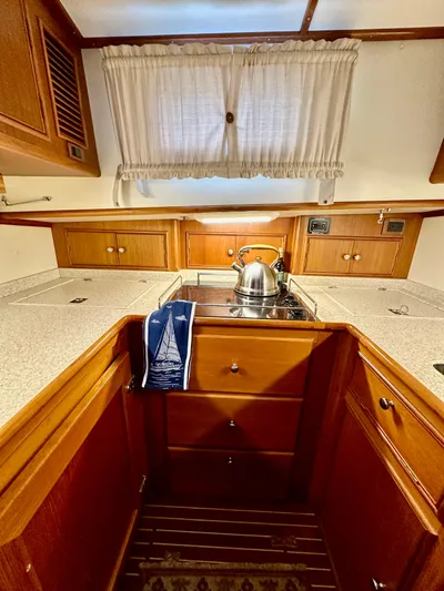 Moonshadow Yacht Photos Pics 2004 Grand Banks 49 Eastbay HX galley with wooden cabinetry and stainless steel kettle.
