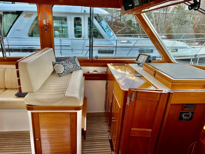 Moonshadow Yacht Photos Pics 2004 Grand Banks 49 Eastbay HX interior with wooden cabinetry and seating.