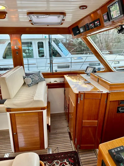 Moonshadow Yacht Photos Pics Interior of 2004 Grand Banks 49 Eastbay HX yacht with wood finish and seating area.