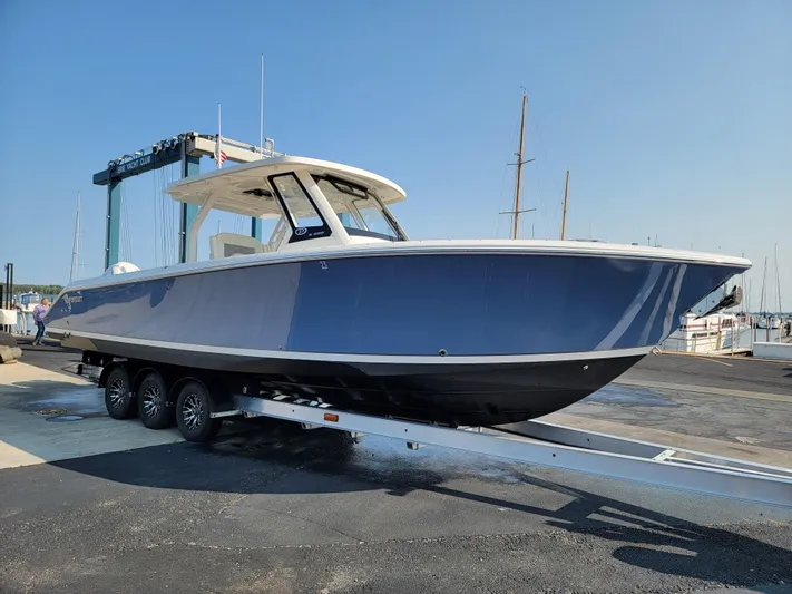 Over Bohr’d Yacht Photos Pics 2023 Pursuit S 328 Sport boat on trailer at marina, side view.
