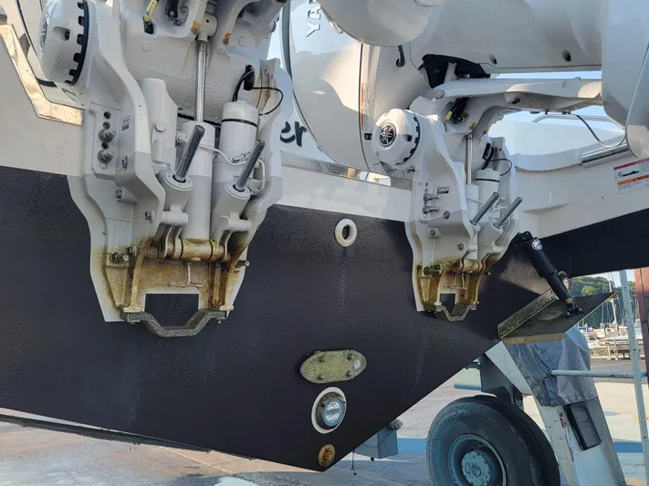 Over Bohr’d Yacht Photos Pics 2023 Pursuit S 328 Sport boat engines on a trailer, showcasing dual outboard motors.