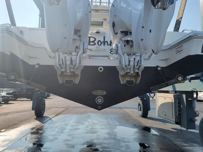 Over Bohr’d Yacht Photos Pics 2023 Pursuit S 328 Sport boat with dual engines, viewed from the rear on a trailer.