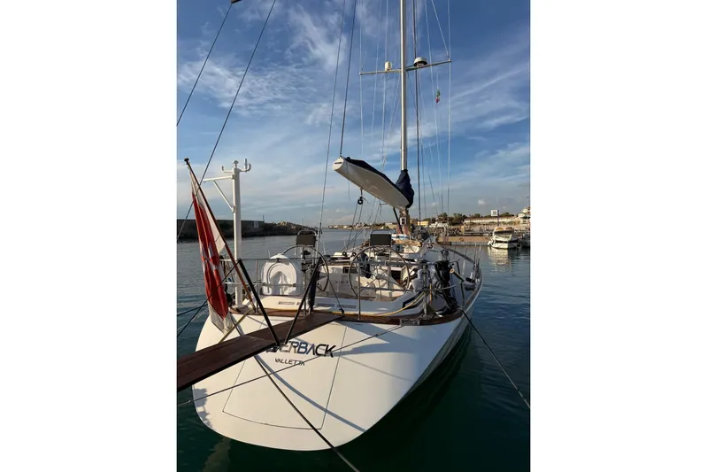 4961 Yacht Photos Pics Swan 60 yacht by Nautor Swan, 2000 model, docked in a serene marina setting.