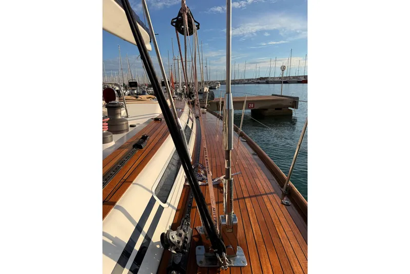 4961 Yacht Photos Pics Nautor Swan 60 yacht deck, 2000 model, with polished wood finish and marina view.