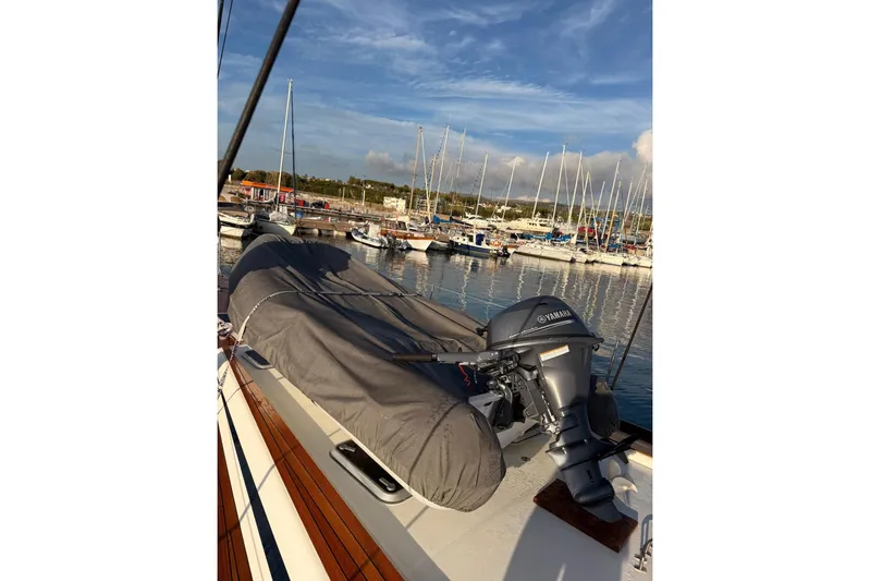 4961 Yacht Photos Pics Swan 60 yacht deck with Yamaha outboard motor, docked at marina, clear sky.