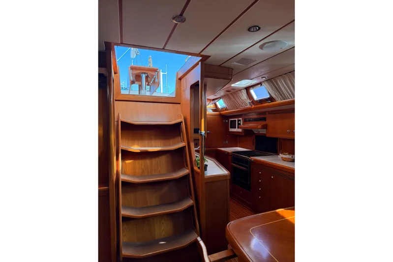4961 Yacht Photos Pics Interior of 2000 Nautor Swan 60 yacht, featuring wooden stairs and a modern kitchen.