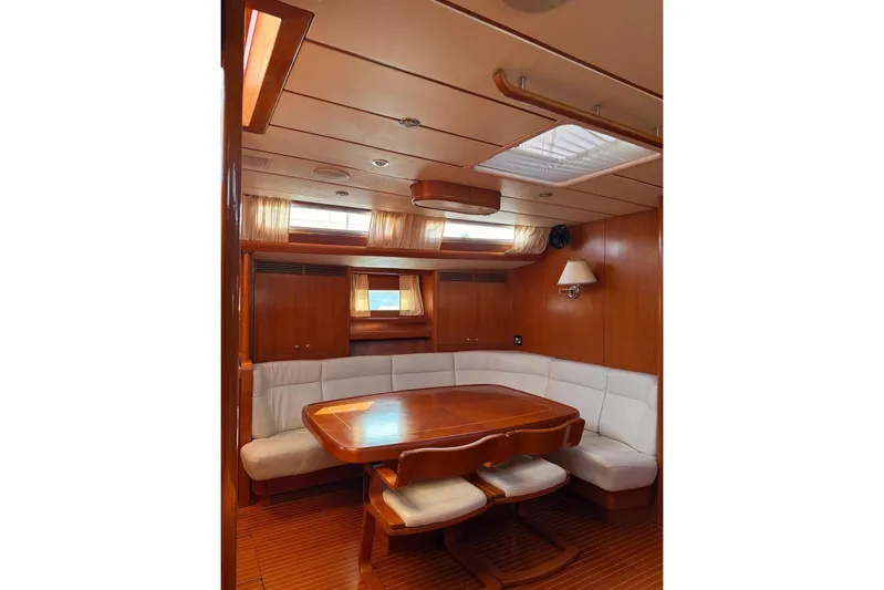 4961 Yacht Photos Pics Luxurious interior of 2000 Nautor Swan 60 yacht with elegant wood finish and plush seating.