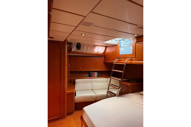4961 Yacht Photos Pics Luxurious interior of 2000 Nautor Swan 60 yacht with wooden finish and cozy seating.