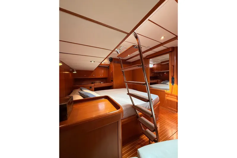 4961 Yacht Photos Pics Luxurious interior of 2000 Nautor Swan 60 yacht with wooden finishes and ladder.