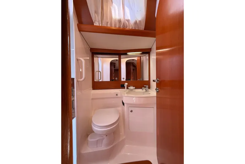 4961 Yacht Photos Pics Luxurious bathroom in 2000 Nautor Swan 60 yacht with wooden accents and modern fixtures.