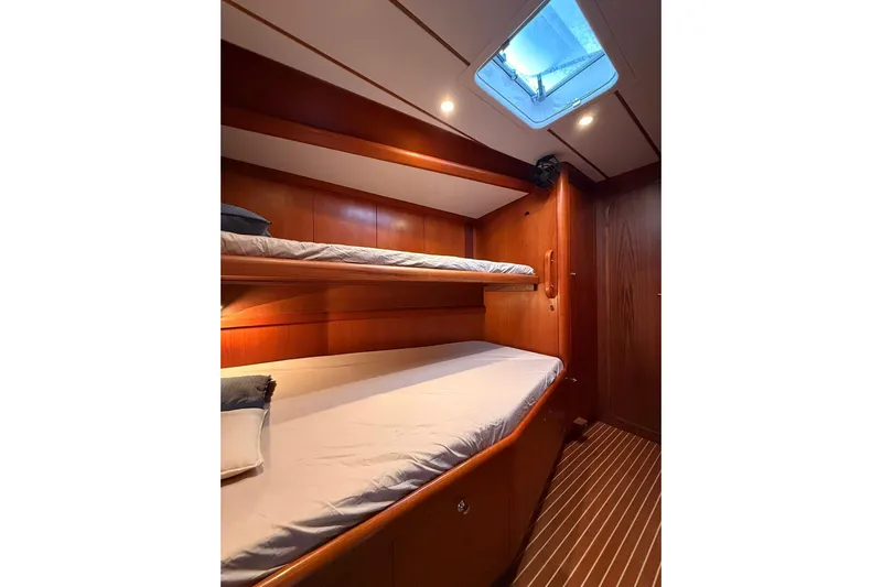 4961 Yacht Photos Pics Cozy cabin with wooden interior and bunk beds on a 2000 Nautor Swan 60 yacht.