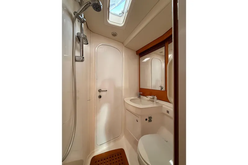 4961 Yacht Photos Pics Bathroom interior of 2000 Nautor Swan 60 yacht, featuring shower, sink, and toilet.