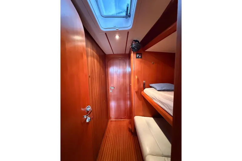 4961 Yacht Photos Pics Cozy cabin interior of 2000 Nautor Swan 60 yacht with wooden finish and bunk beds.