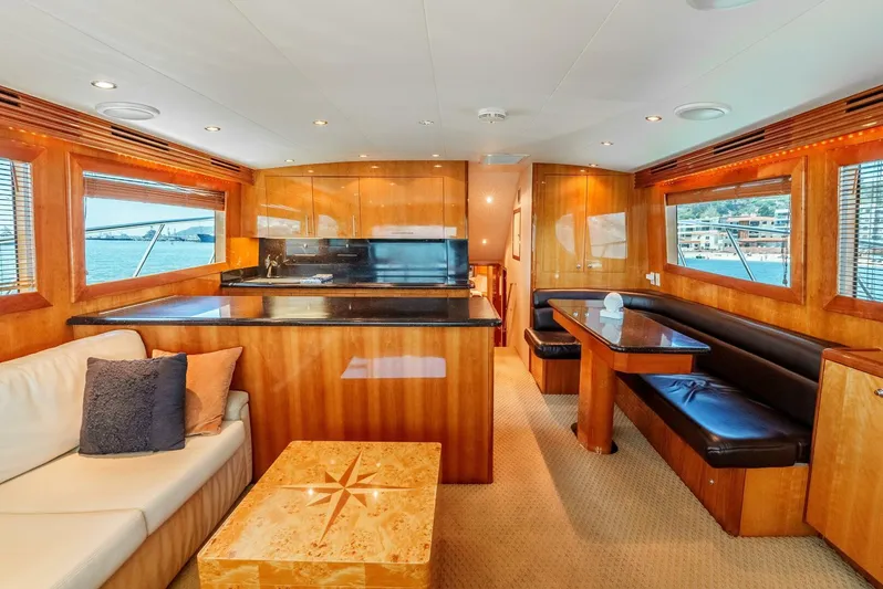 Reel Ranchin Yacht Photos Pics Luxurious interior of 2004 Hatteras 54 Convertible yacht with elegant wood finishes and seating.