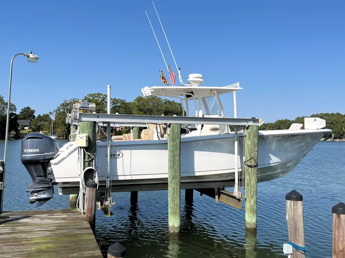 Salty Rim Yacht Photos Pics 2015 Sea Hunt Gamefish 30 with Coffin Box on a lift at a dock.