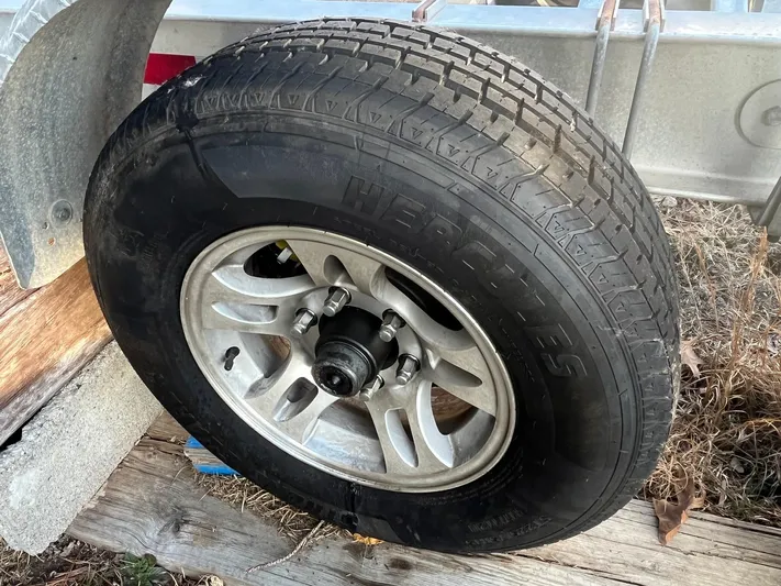 Salty Rim Yacht Photos Pics Trailer wheel for 2015 Sea Hunt Gamefish 30 with Coffin Box, mounted on metal frame.