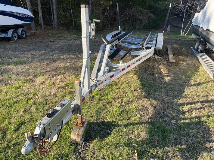 Salty Rim Yacht Photos Pics Trailer for 2015 Sea Hunt Gamefish 30 with Coffin Box, parked on grass.