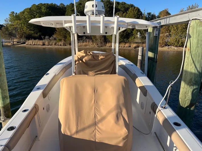 Salty Rim Yacht Photos Pics 2015 Sea Hunt Gamefish 30 with Coffin Box docked by a serene waterfront.