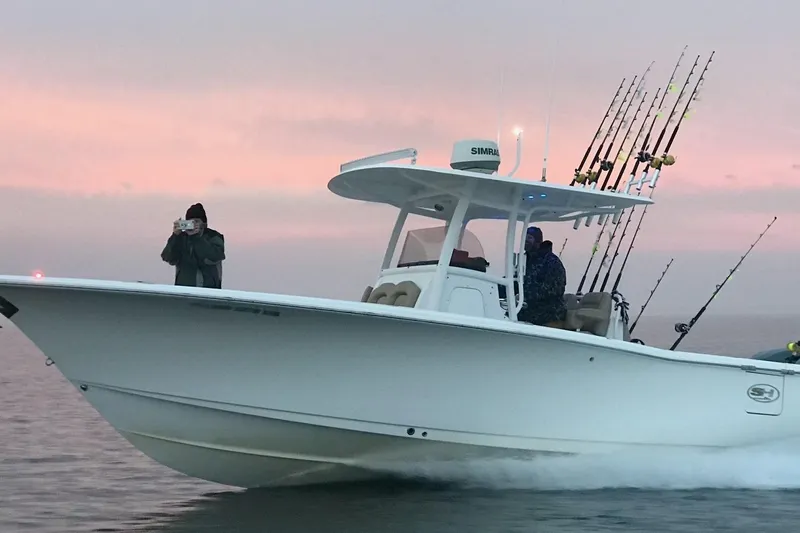 Salty Rim Yacht Photos Pics 2015 Sea Hunt Gamefish 30 boat with fishing rods at sunset.