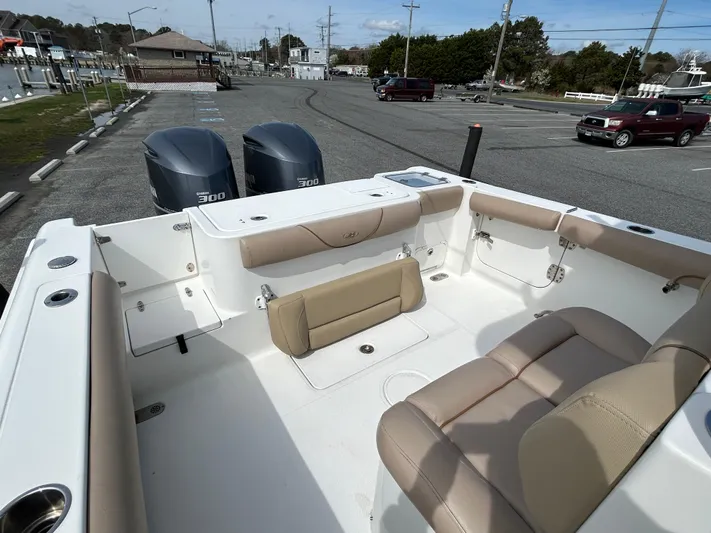 Salty Rim Yacht Photos Pics 2015 Sea Hunt Gamefish 30 boat interior with seating and twin engines in a parking area.