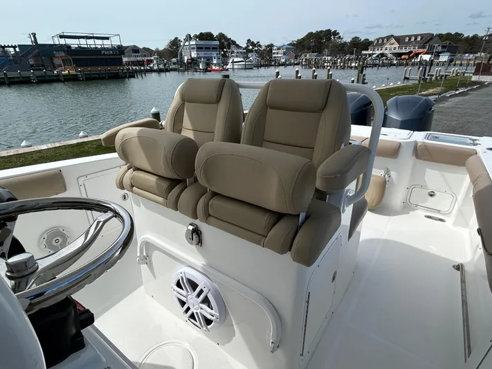 Salty Rim Yacht Photos Pics 2015 Sea Hunt Gamefish 30 boat interior with dual seats and steering wheel, docked by the water.