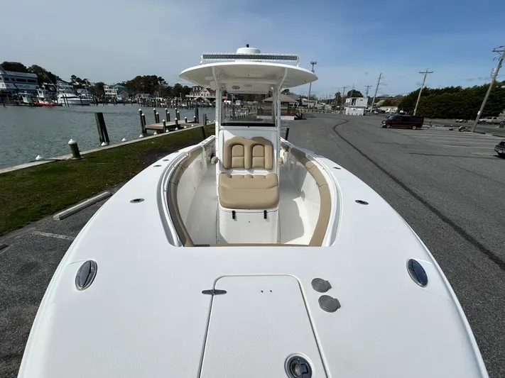 Salty Rim Yacht Photos Pics 2015 Sea Hunt Gamefish 30 with Coffin Box, docked near a marina, showcasing spacious deck.