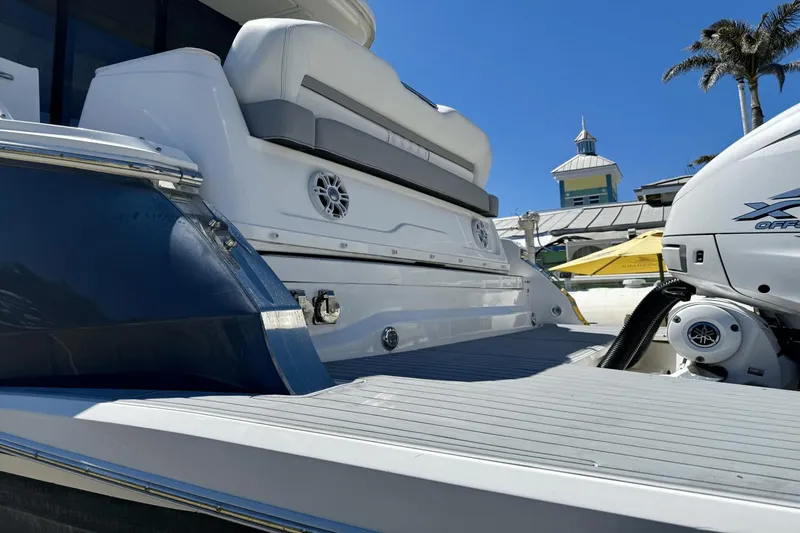  Yacht Photos Pics 2023 Regal 36 XO boat with sleek design, spacious deck, and powerful outboard motor.