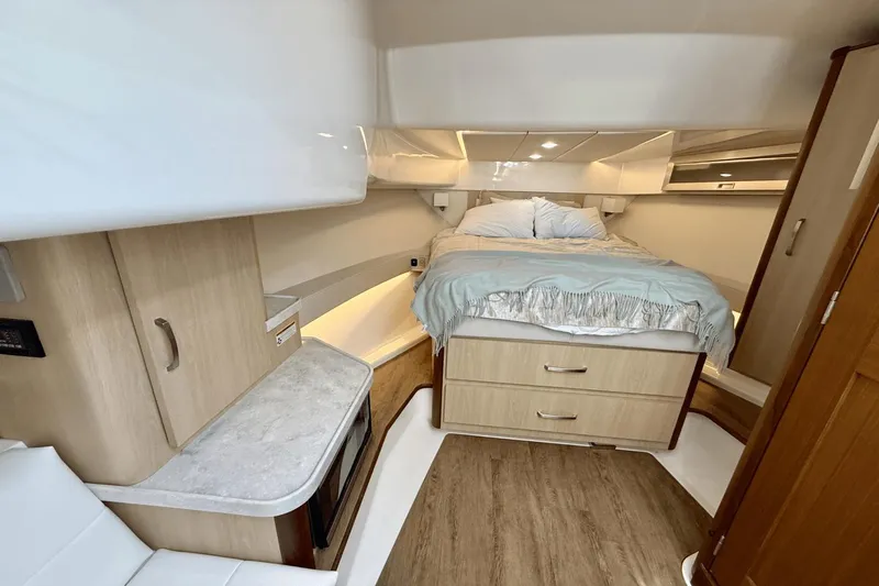  Yacht Photos Pics Luxurious interior of 2023 Regal 36 XO yacht with cozy bed and modern amenities.