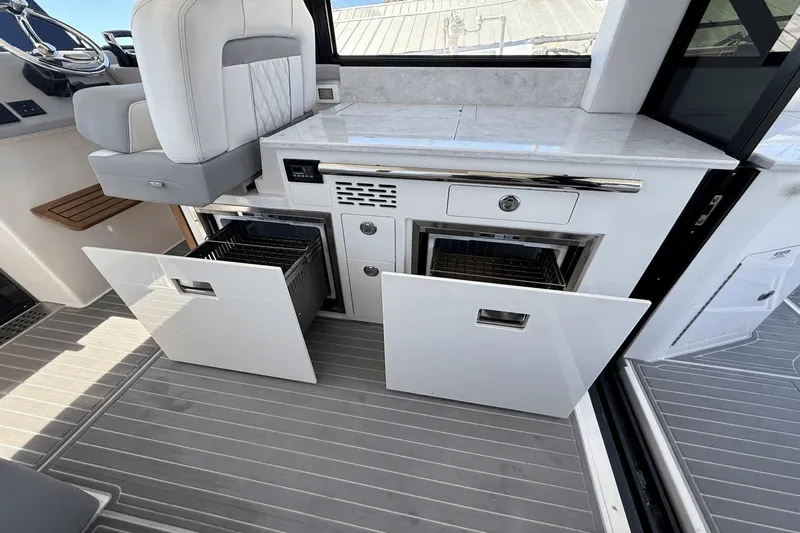  Yacht Photos Pics 2023 Regal 36 XO yacht interior with open storage compartments and modern design.