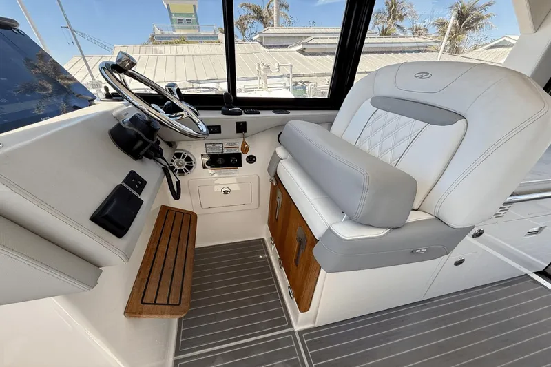  Yacht Photos Pics 2023 Regal 36 XO boat helm with luxurious seating and modern controls.