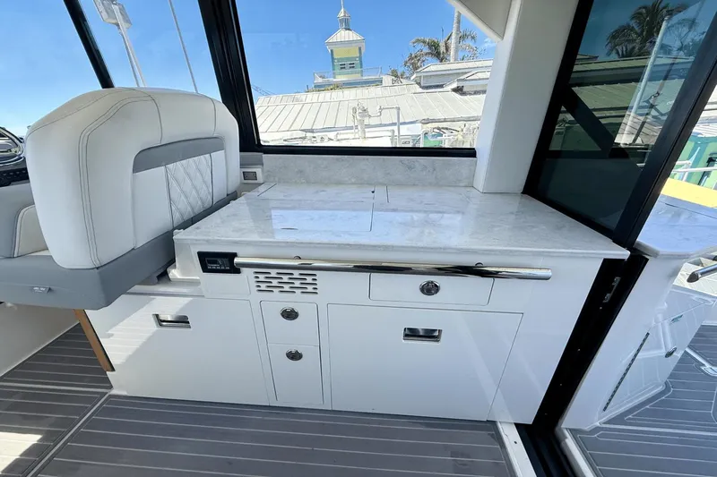  Yacht Photos Pics Luxurious interior of 2023 Regal 36 XO yacht with sleek white cabinetry and seating.