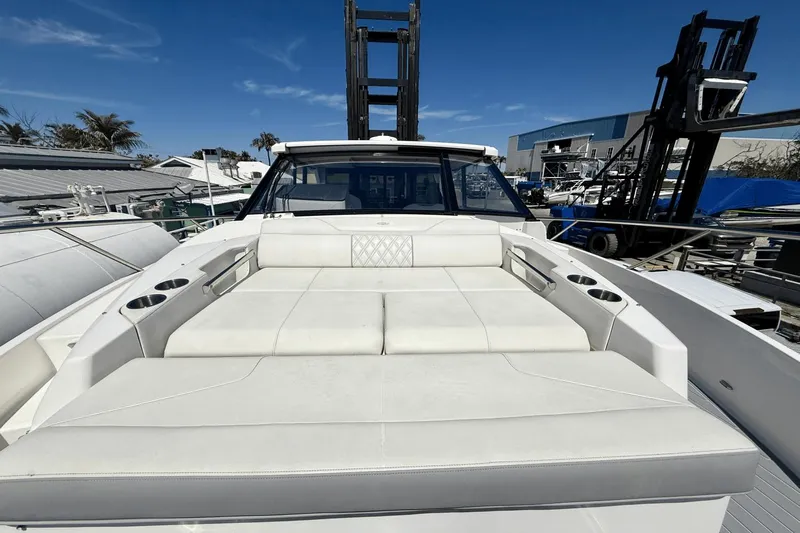  Yacht Photos Pics 2023 Regal 36 XO yacht with spacious white deck seating under clear blue sky.