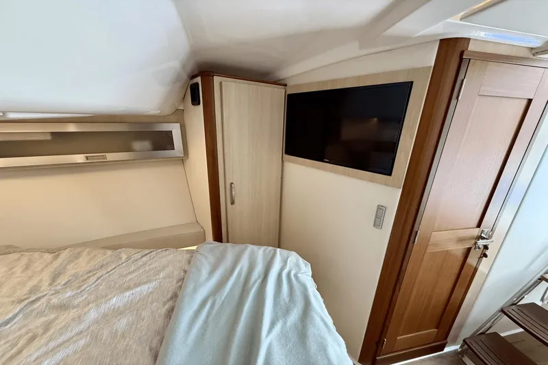  Yacht Photos Pics Interior of 2023 Regal 36 XO yacht cabin with TV and wooden door.