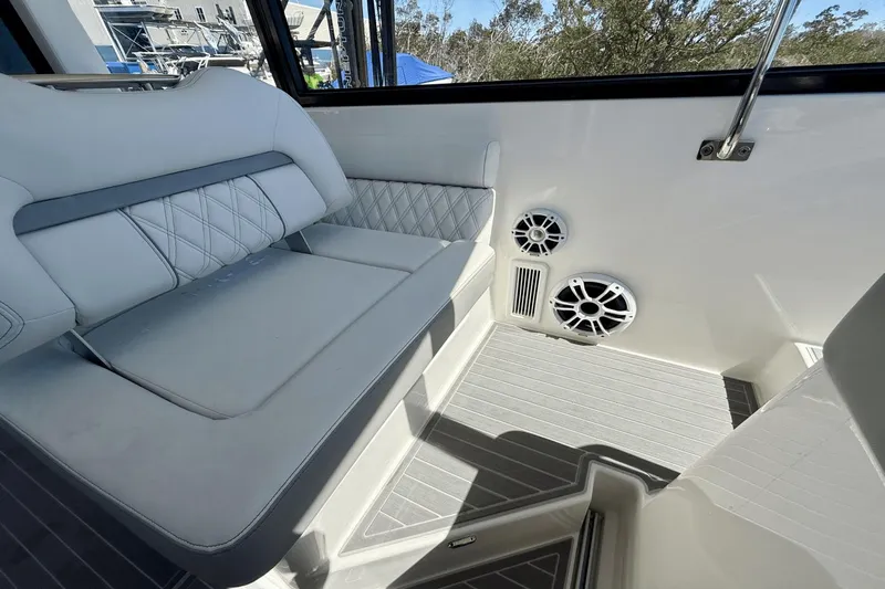  Yacht Photos Pics Luxurious seating area on 2023 Regal 36 XO boat with speakers and elegant design.