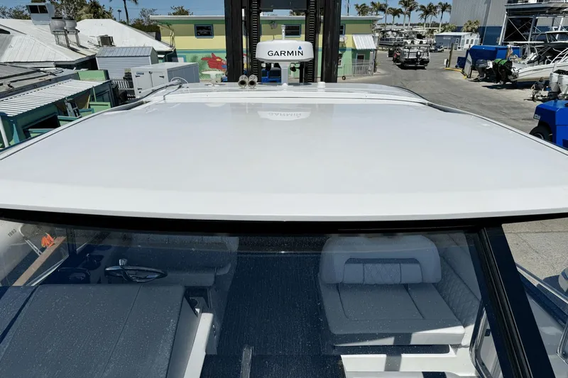 Yacht Photos Pics 2023 Regal 36 XO boat roof view with Garmin equipment in a marina setting.