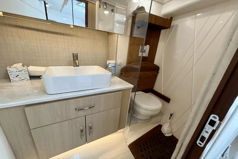  Yacht Photos Pics Modern bathroom in 2023 Regal 36 XO yacht with sleek sink and toilet.
