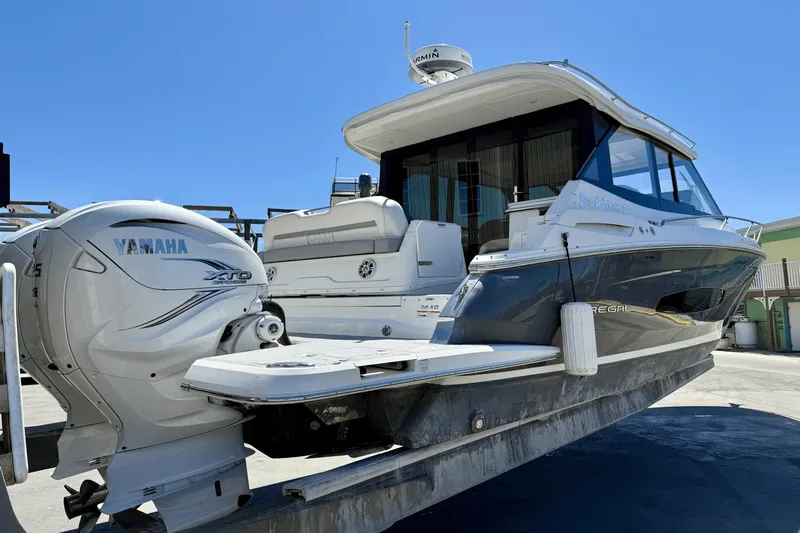  Yacht Photos Pics 2023 Regal 36 XO boat with Yamaha XTO outboard engine, docked under clear blue sky.