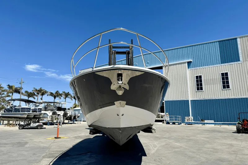  Yacht Photos Pics 2023 Regal 36 XO boat in a marina, clear blue sky background.
