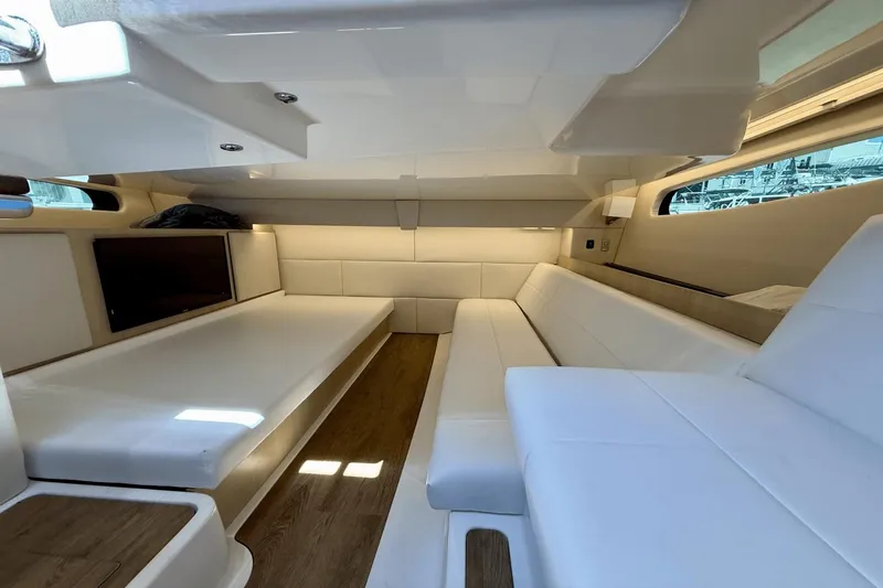  Yacht Photos Pics 2023 Regal 36 XO yacht interior with white seating and wood flooring.