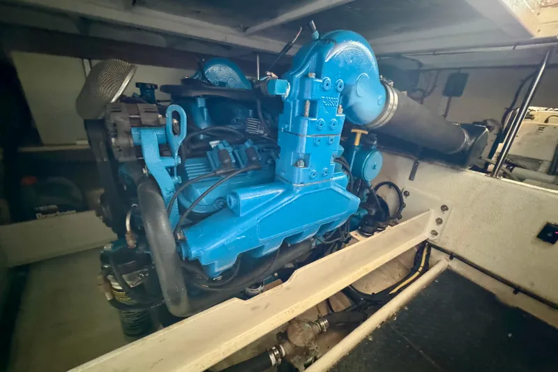  Yacht Photos Pics Engine compartment of a 2006 Silverton 38 Sport Bridge, featuring a blue marine engine.