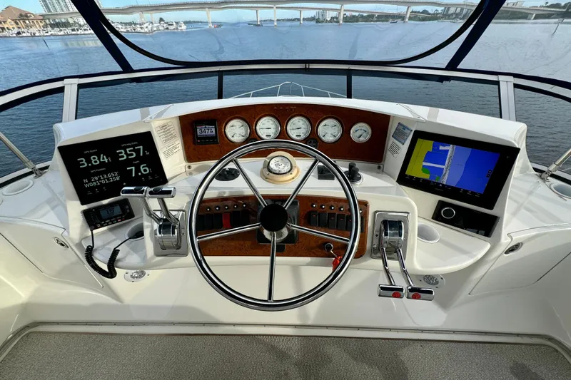  Yacht Photos Pics Helm of 2006 Silverton 38 Sport Bridge with navigation screens and controls, overlooking waterway.