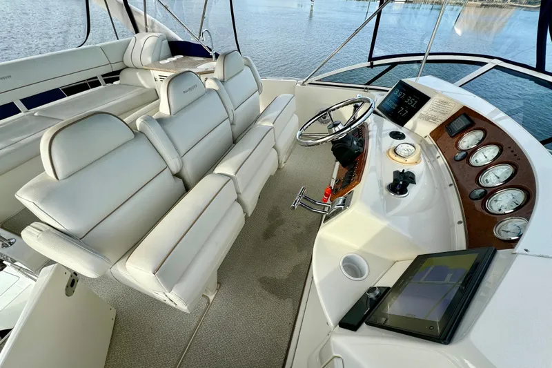  Yacht Photos Pics 2006 Silverton 38 Sport Bridge helm with white seating and modern controls.