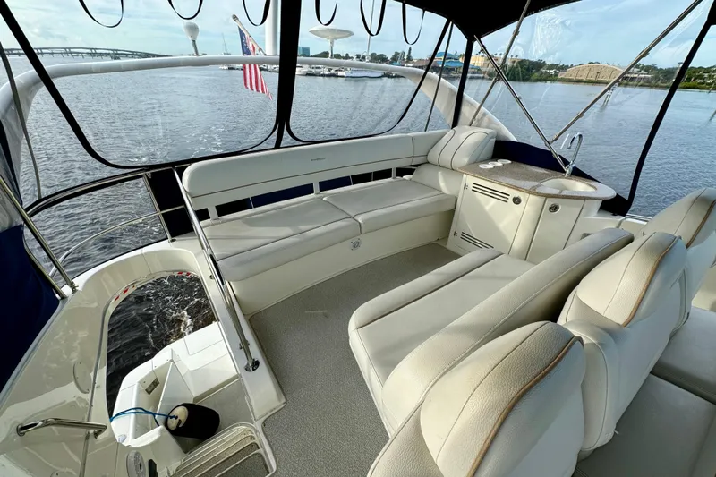  Yacht Photos Pics 2006 Silverton 38 Sport Bridge interior with plush seating and water view.
