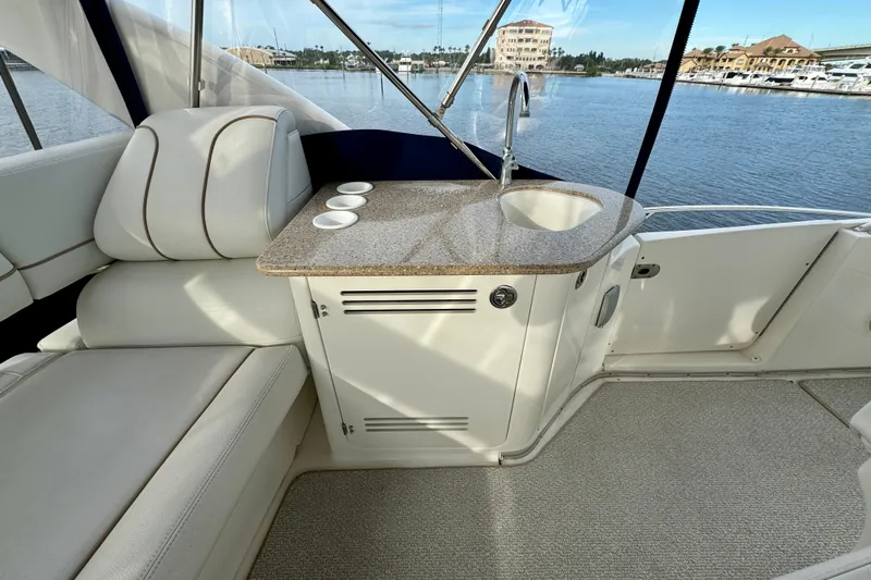 Yacht Photos Pics 2006 Silverton 38 Sport Bridge interior with sink and seating, overlooking marina.