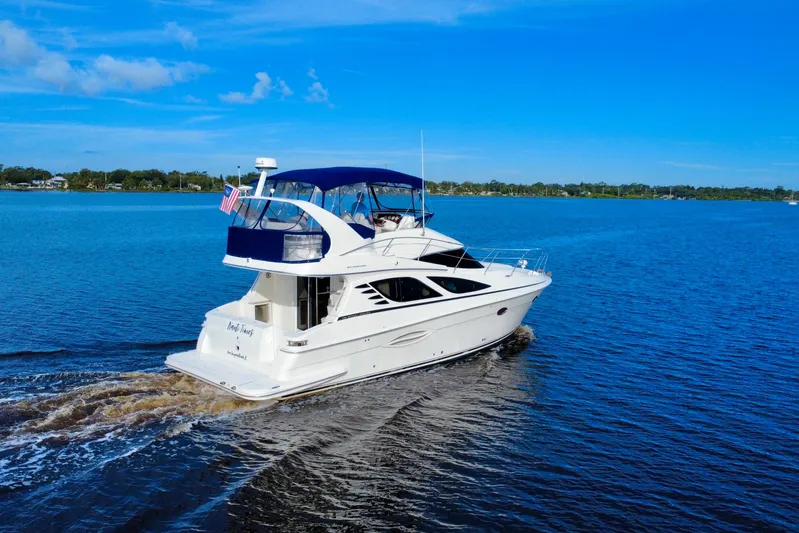  Yacht Photos Pics 2006 Silverton 38 Sport Bridge yacht cruising on a clear blue lake.