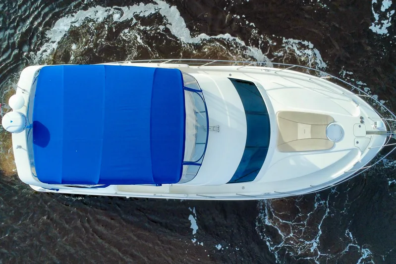  Yacht Photos Pics Overhead view of 2006 Silverton 38 Sport Bridge yacht with blue canopy on water.
