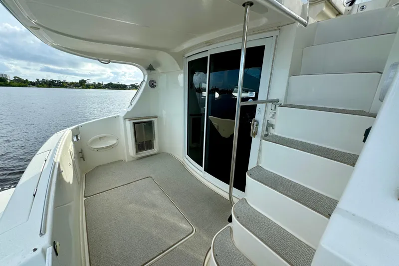  Yacht Photos Pics 2006 Silverton 38 Sport Bridge yacht deck with stairs and sliding glass doors.