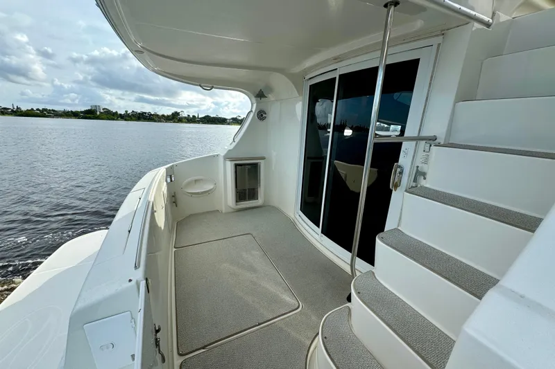  Yacht Photos Pics 2006 Silverton 38 Sport Bridge yacht deck with stairs and waterfront view.