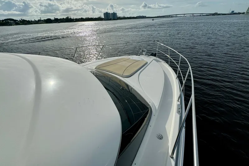  Yacht Photos Pics 2006 Silverton 38 Sport Bridge yacht on calm waters under a cloudy sky.