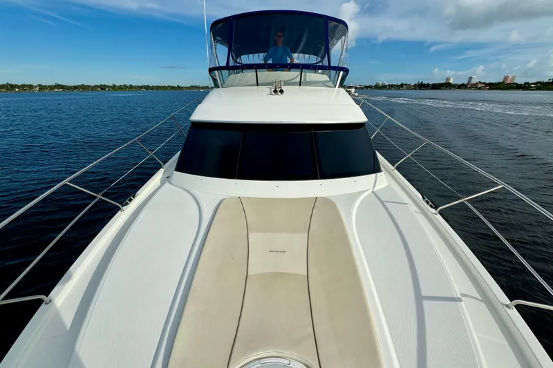  Yacht Photos Pics 2006 Silverton 38 Sport Bridge yacht cruising on a calm blue sea.